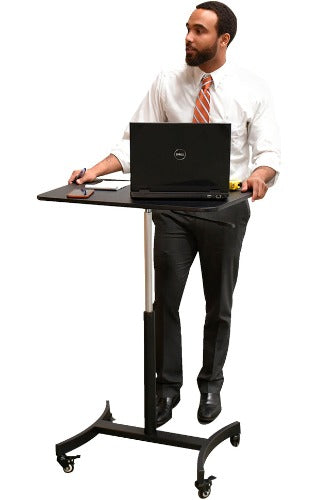 Victor DC500 Hick Rise Mobile adjustable desk cart being used by a person with a computer, calculator and notepad on top of the desk.